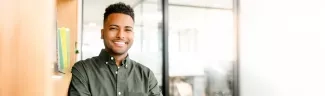 A young man wearing a green khaki shirt.