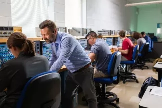 Several people seated at work stations.