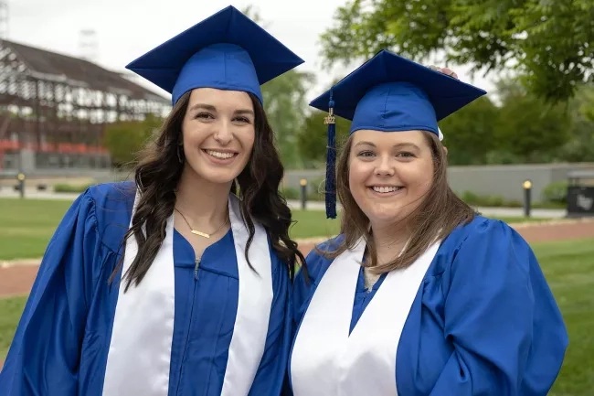 two young women happy to be graduating