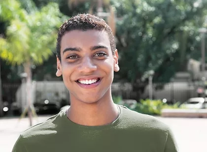 A young man wearing a green shirt