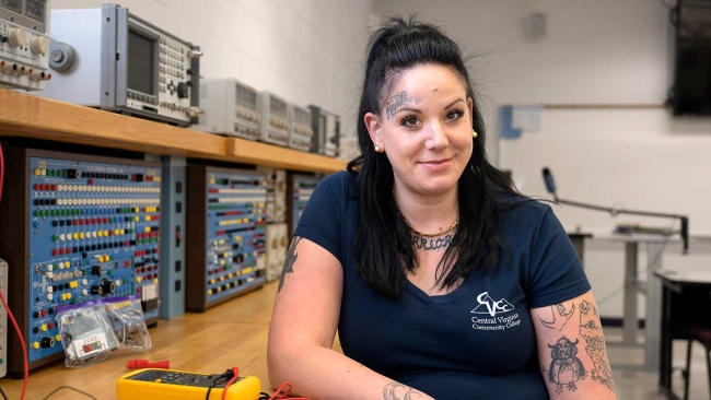 female mechatronics student smiling at camera